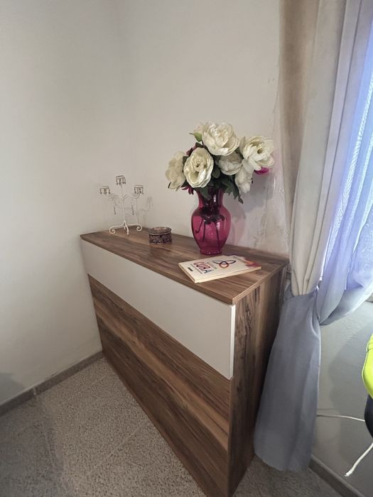 Quarto casal com mesas de cabeceiras e cómoda.