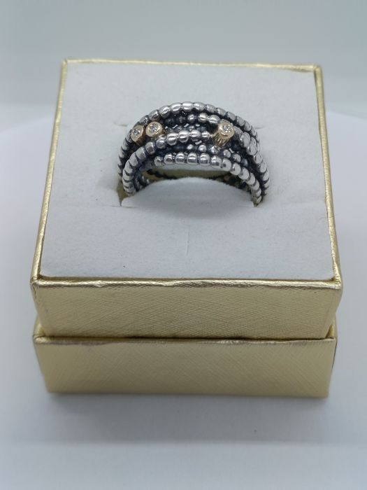 QSrebrny pierścionek-obrączka, w próbie 925, z 14- karatowym złotem i diamentami-0 03ct. Pandora. Noszony.
