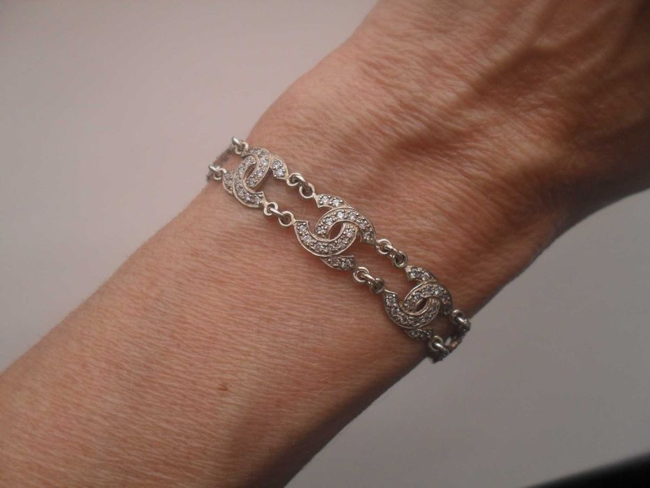 Srebrna bransoletka - motyw CC z kryształami - cena ost