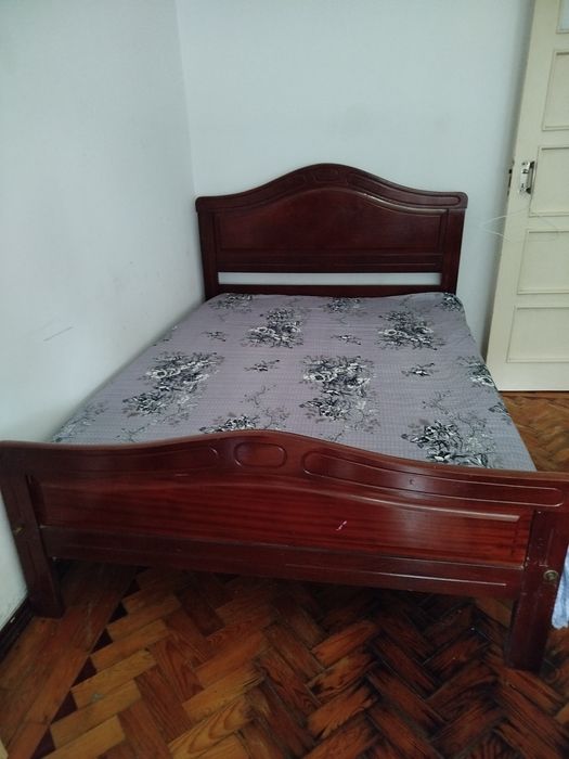 A wooden double bed for sale