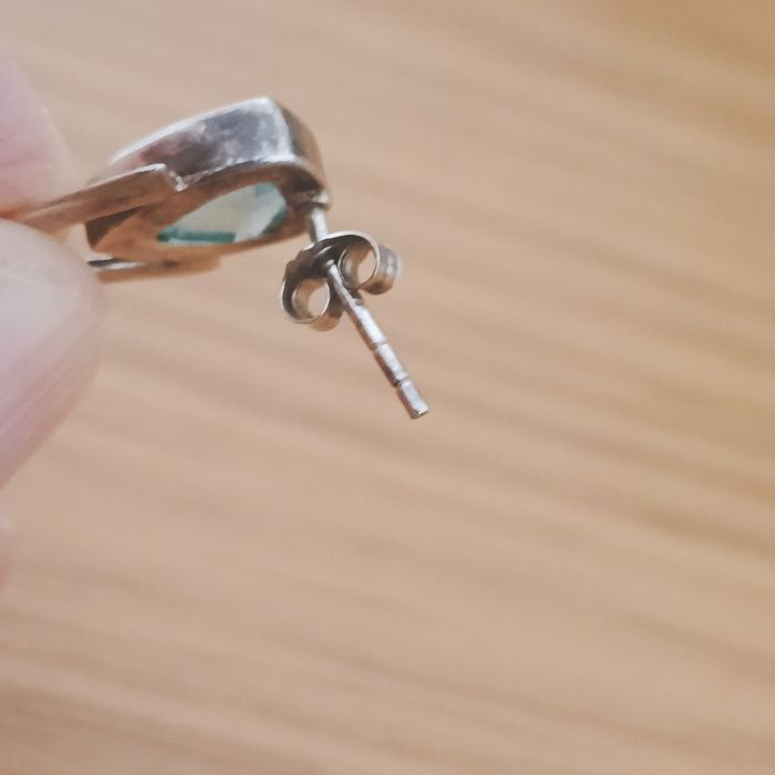 Brincos em prata com contraste e pedra azul.