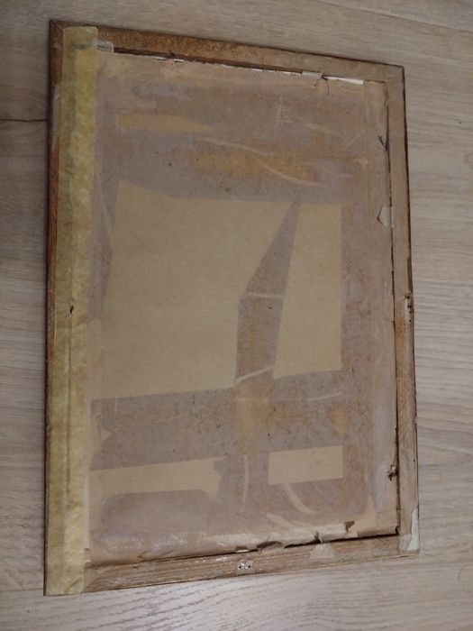 Obrazek w ramce. Dwoje ludzi pod drzewem.