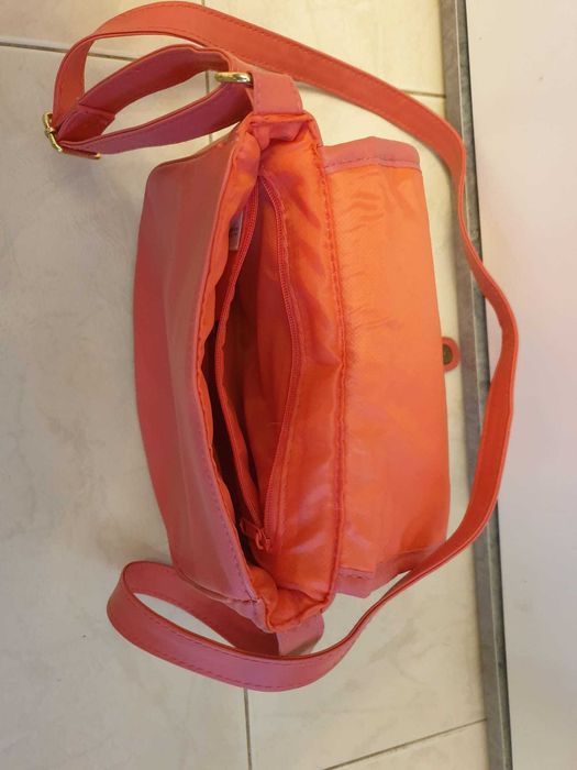 Mala cor de rosa a tiracolo