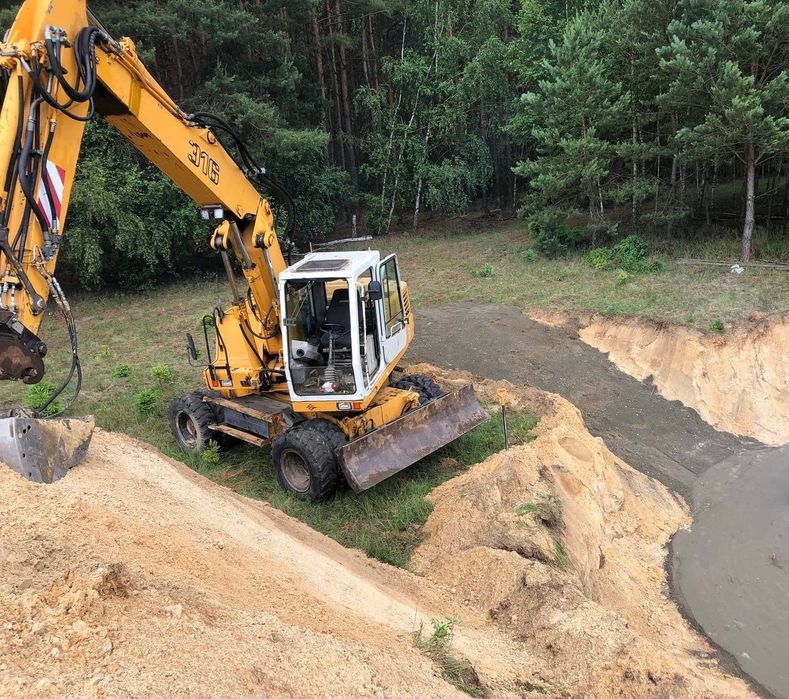 Usługi koparko-ładowarką,koparką kołową,ziemia,piach,wyburzenia