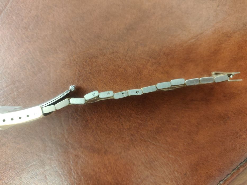 Bracelete Omega em aço plaqueada a ouro