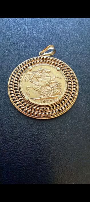 Medalha libra em ouro de 22kt com aro de 19,2kt