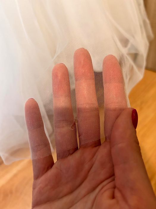 Suknia ślubna z gorsetową górą oraz kwiatowymi dekoracjami.