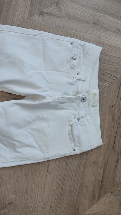 Białe spodnie damskie jeansy z zamkami S 36
