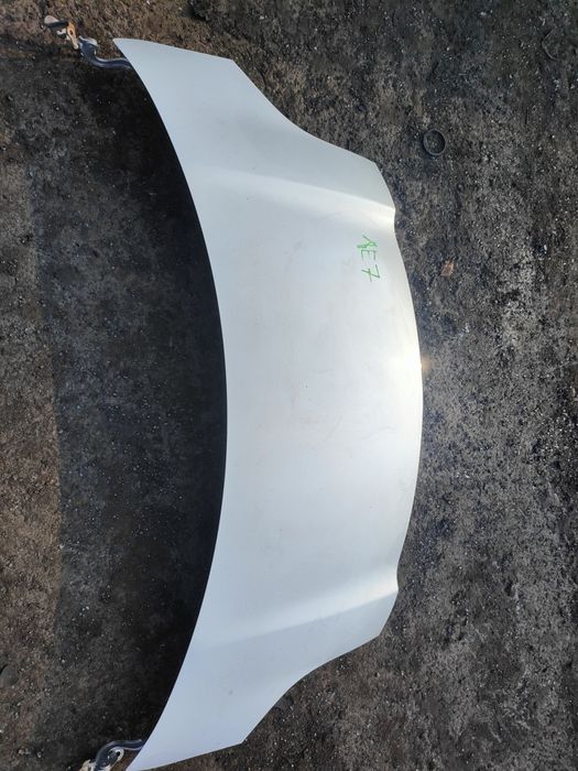 Toyota Yaris 2 II maska przód srebrna 1E7