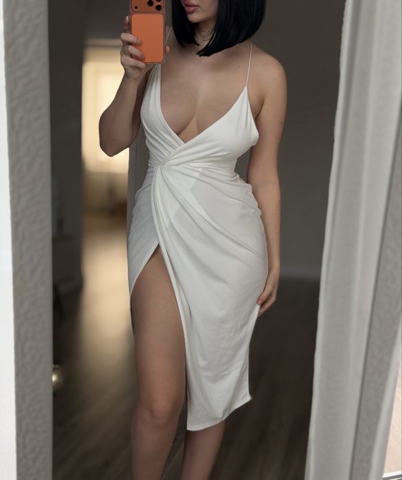 Розкішна біла вечірня сукня з глибоким декольте та розрізом