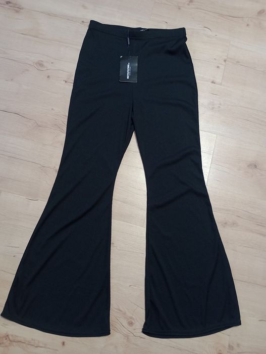 Nowe Spodnie dzwony rozszerzane nogawki Prettylittlething 42 L XL