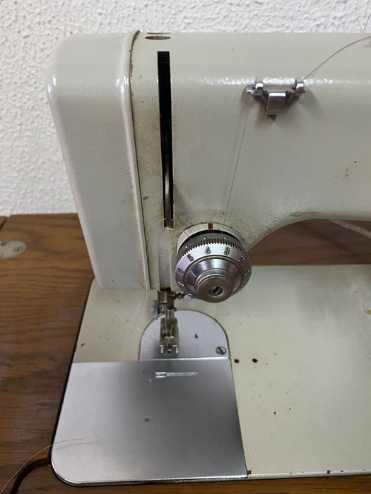 Máquina de costura antiga com móvel