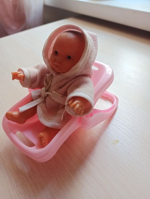 Маленький пупс у кошику