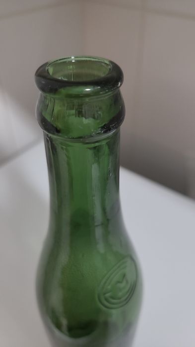 Antiga garrafa de cerveja gravada em alto relevo nas laterais