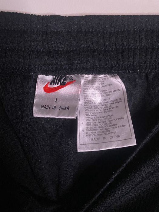 Calças Nike pretas com botões laterais (snap pants)