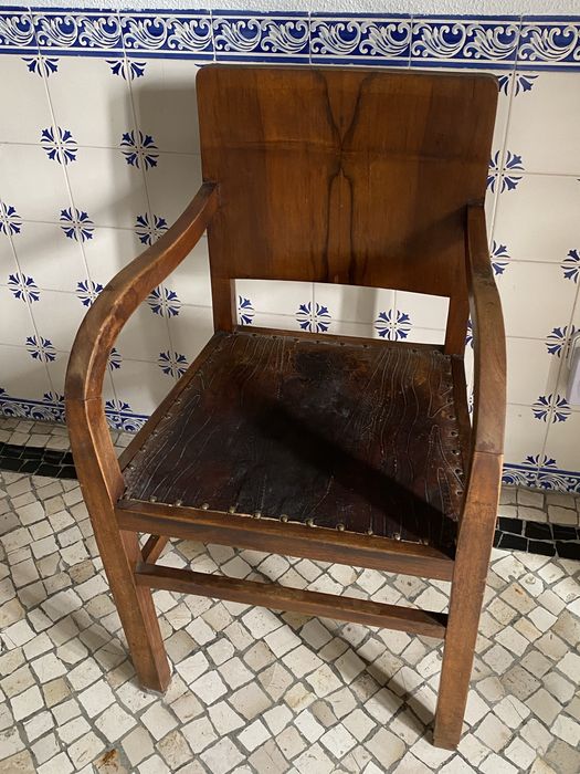 Cadeira de braços muito antiga com assento em couro