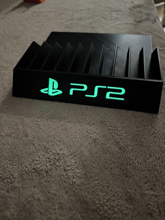 Stojak podstawka na gry PlayStation 2 napis fluorescencyjny