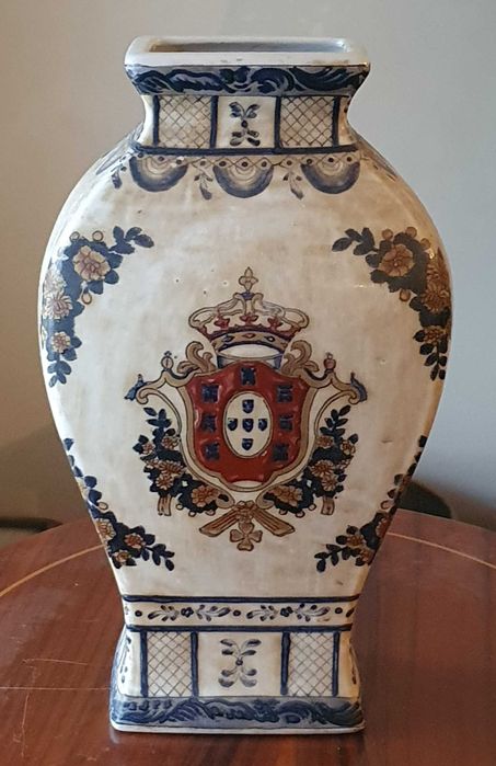 Hand-painted porcelain jug featuring the coat of arms of Portugal.