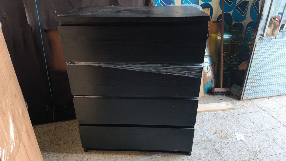 Cómoda preta 4 gavetas com algumas marcas de uso mas funcional