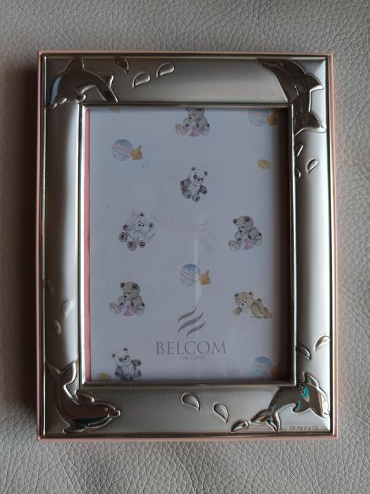 Silver mat board with dolphin motif.64738403931266121
