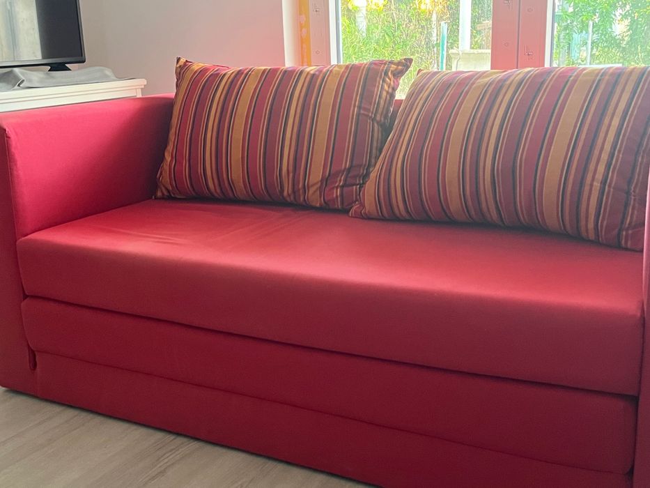 Sofá vermelho semi-novo com cama extensível
