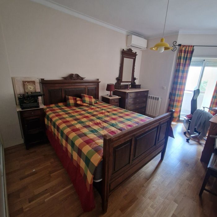 Quarto clássico, cama, cómoda e mesas de cabeceira