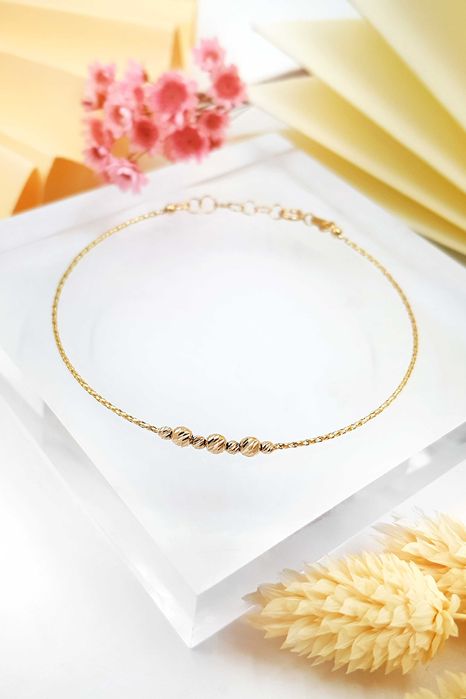 Złota bransoletka z diamentowanymi koralikami z żółtego złota pr. 585