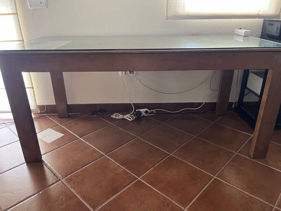 Secretária de madeira maciça. Tampo protegido com vidro.