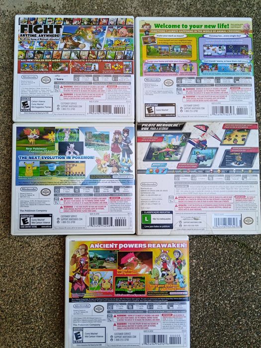 3 caixas e manuais de jogos Nintendo 3DS versão americana.