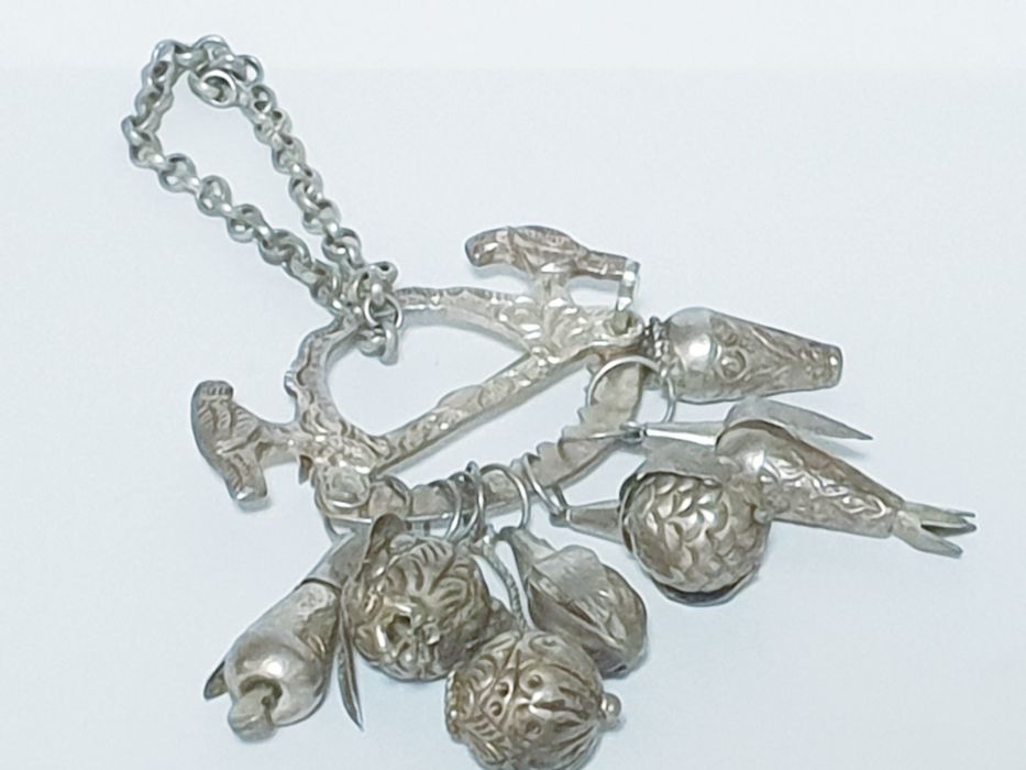 Beautiful brooch with contrasting silver buckle and charms