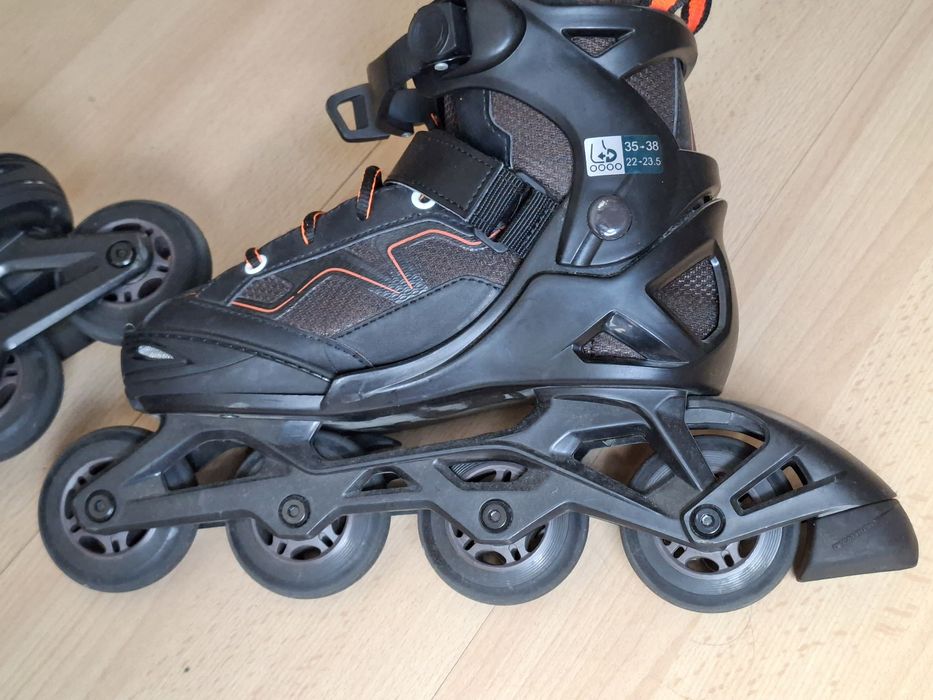 Patins em linha pretos e laranja da Olexo