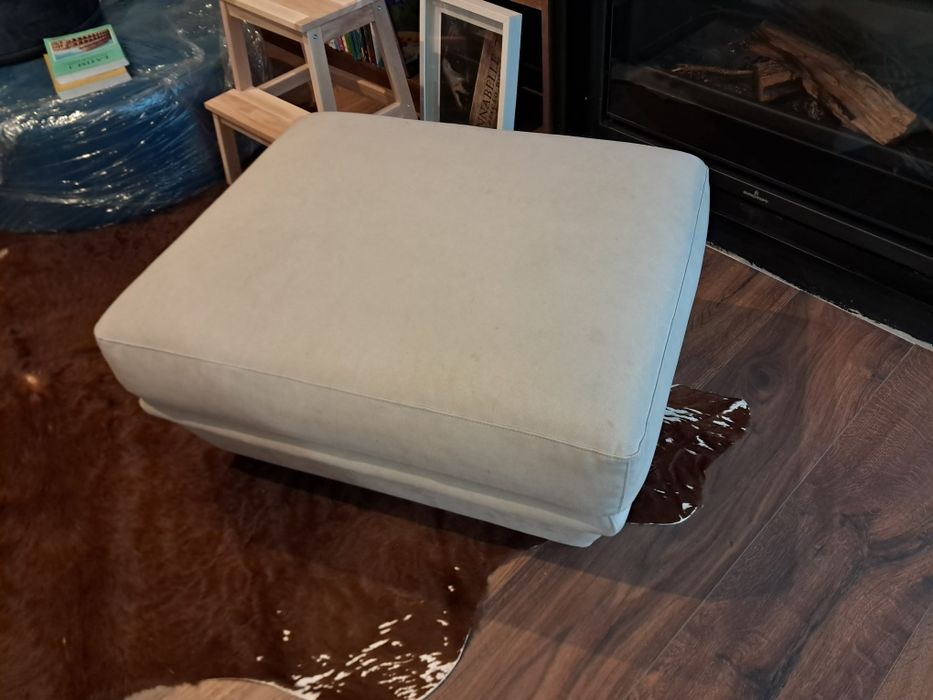 Pufe creme aveludado com pés em madeira