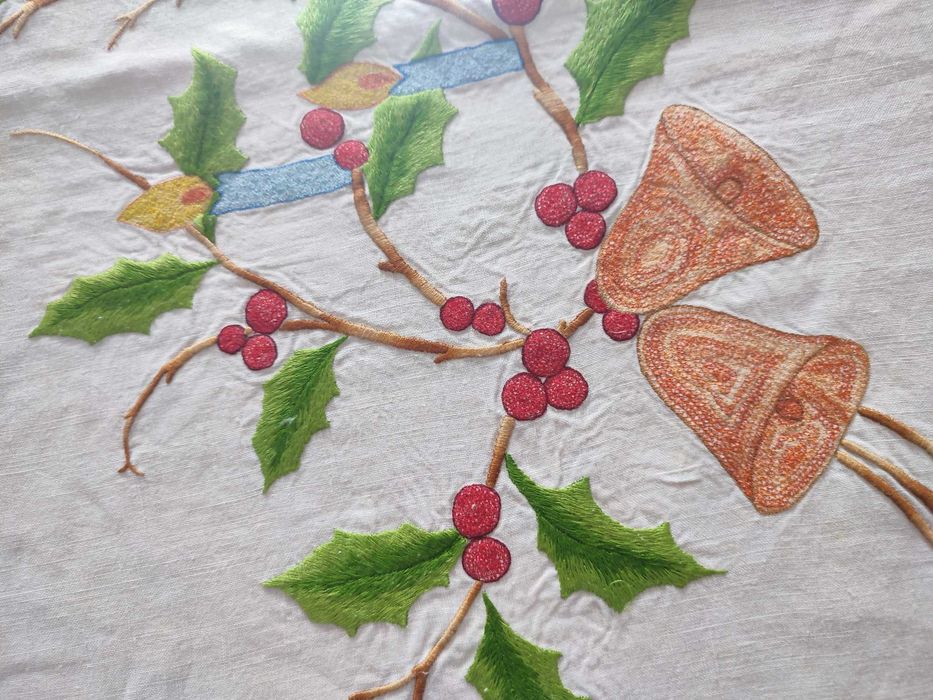 Toalha de natal branca com bordados natalícios.