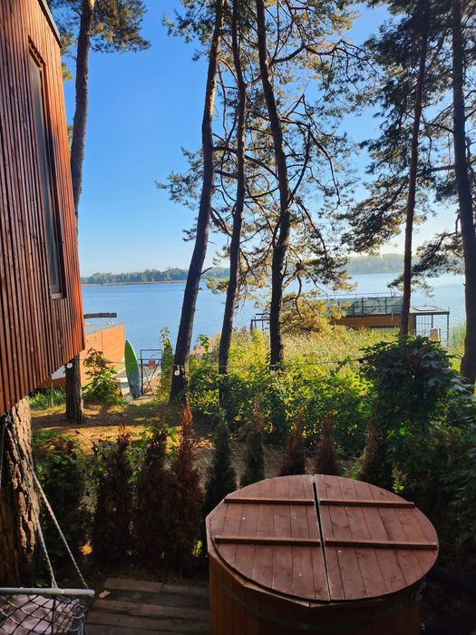 Domek na drzewie z jacuzzi nad brzegiem jeziora. Domek nad wodą
