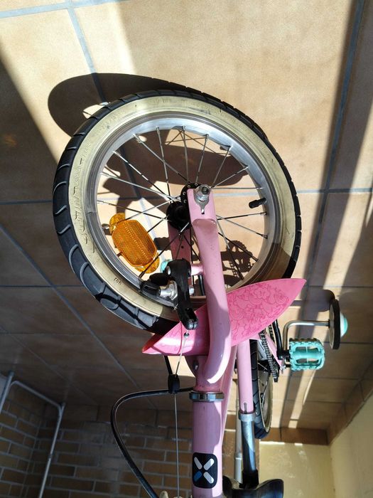 Bicicleta infantil rosa com rodinhas de apoio