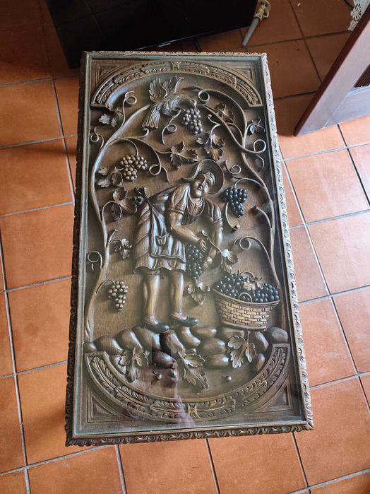 Mesa de centro, ricamente esculpida à mão, com cena de vindima.