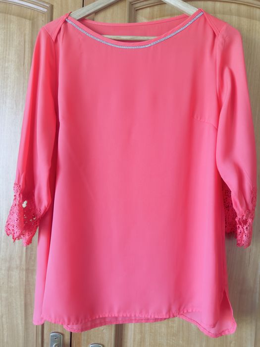 Blusa de senhora, na cor coral. Veste um L.