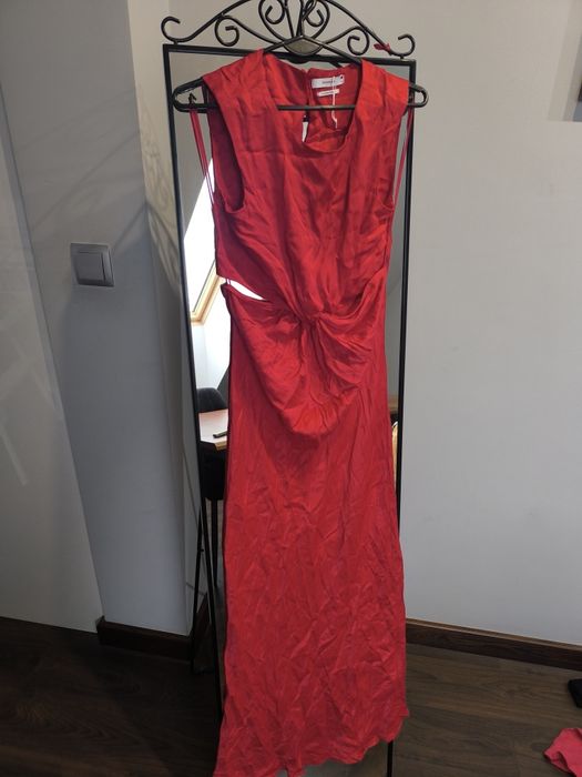 Czerwona sukienka z wyciętymi bokami.