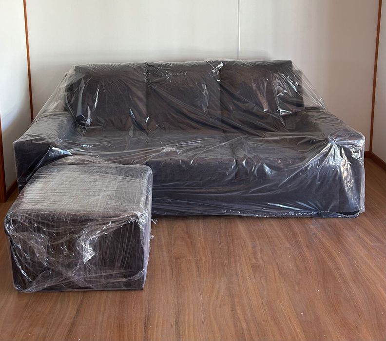 Sofá preto de 3 lugares com apoio de pés