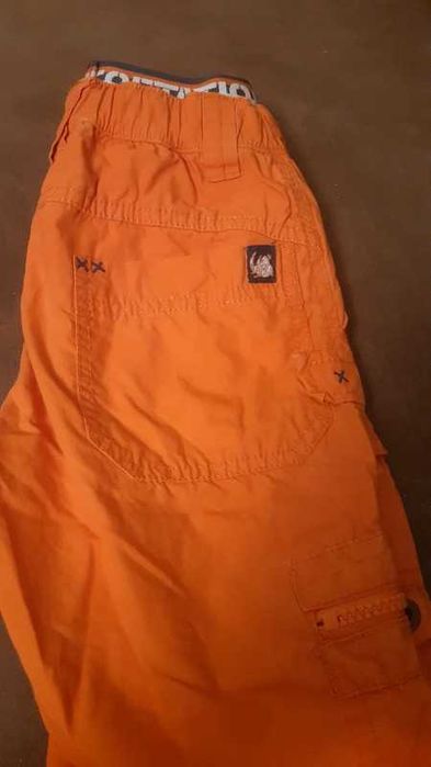 Pomarańczowe spodnie sportowe dla chłopca H&M 92