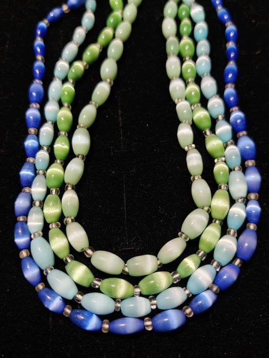 Zestaw czterech naszyjników w różnych kolorach