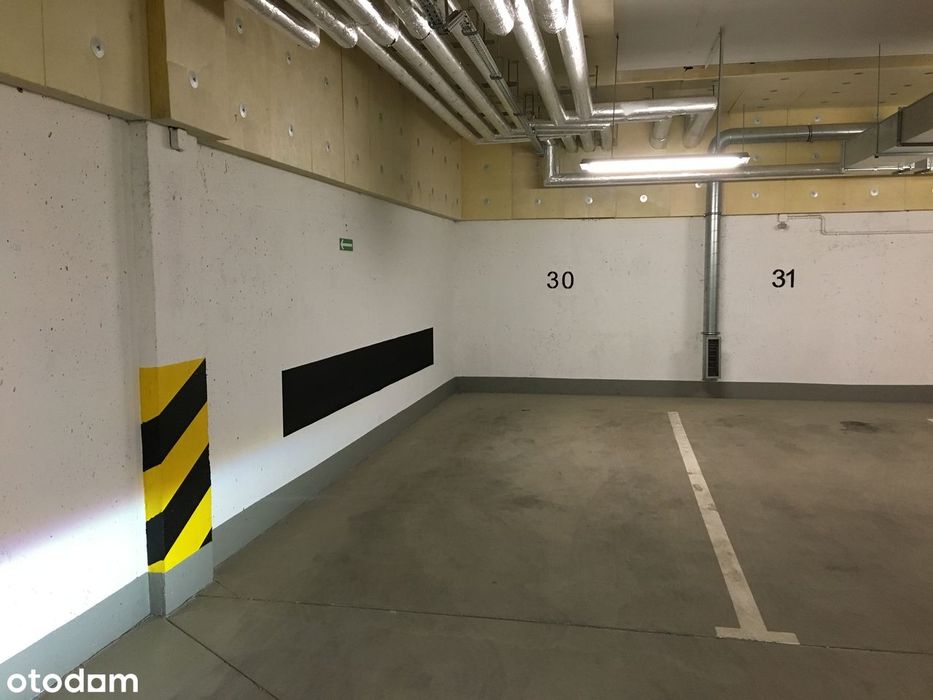 Miejsce parkingowe w garażu podziemnym budynku mieszkalnego