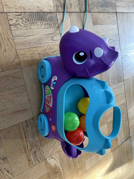 Іграшка каталка Fisher price динозавр веселий трицератопс
