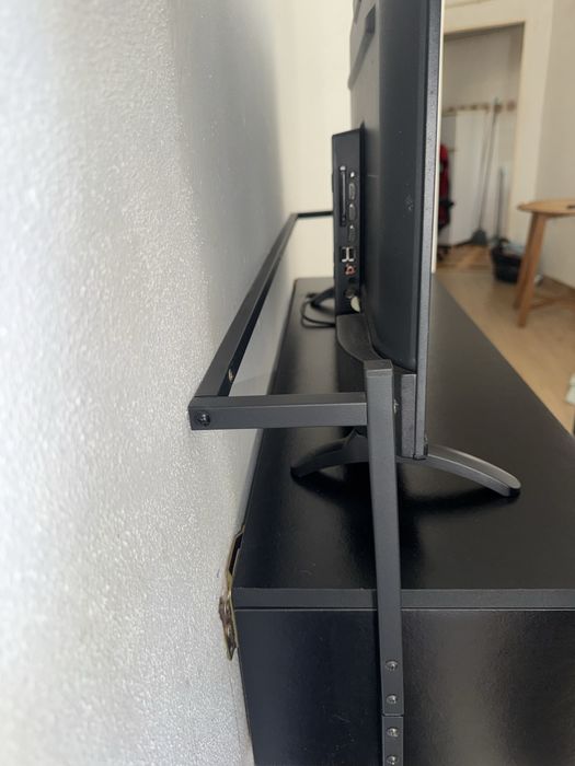 Estante preta pendurada para tv