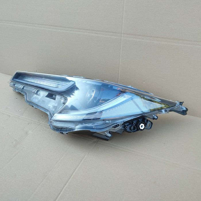 Toyota Corolla XII E21 kombi HB lampa lewa reflektor oryginał EU