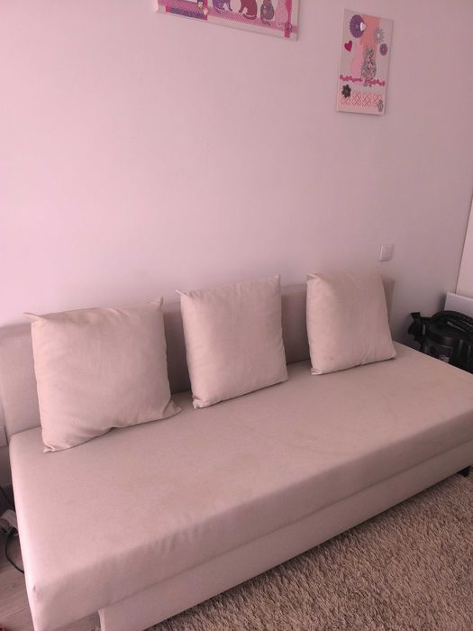 Sofá cama bege com arrumação e almofadas incluídas