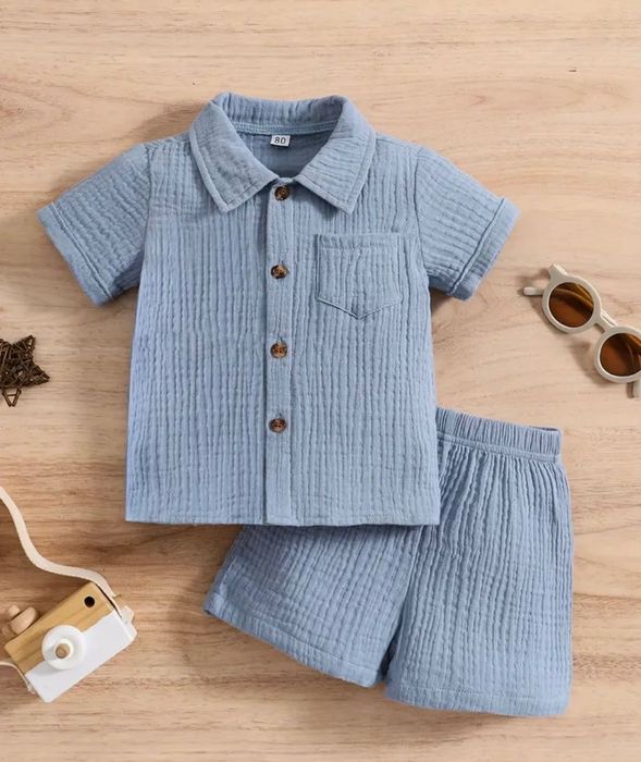 Nowy Muślinowy, niebieski zestaw spodenki i koszula, bawełna 6 - 9 m.