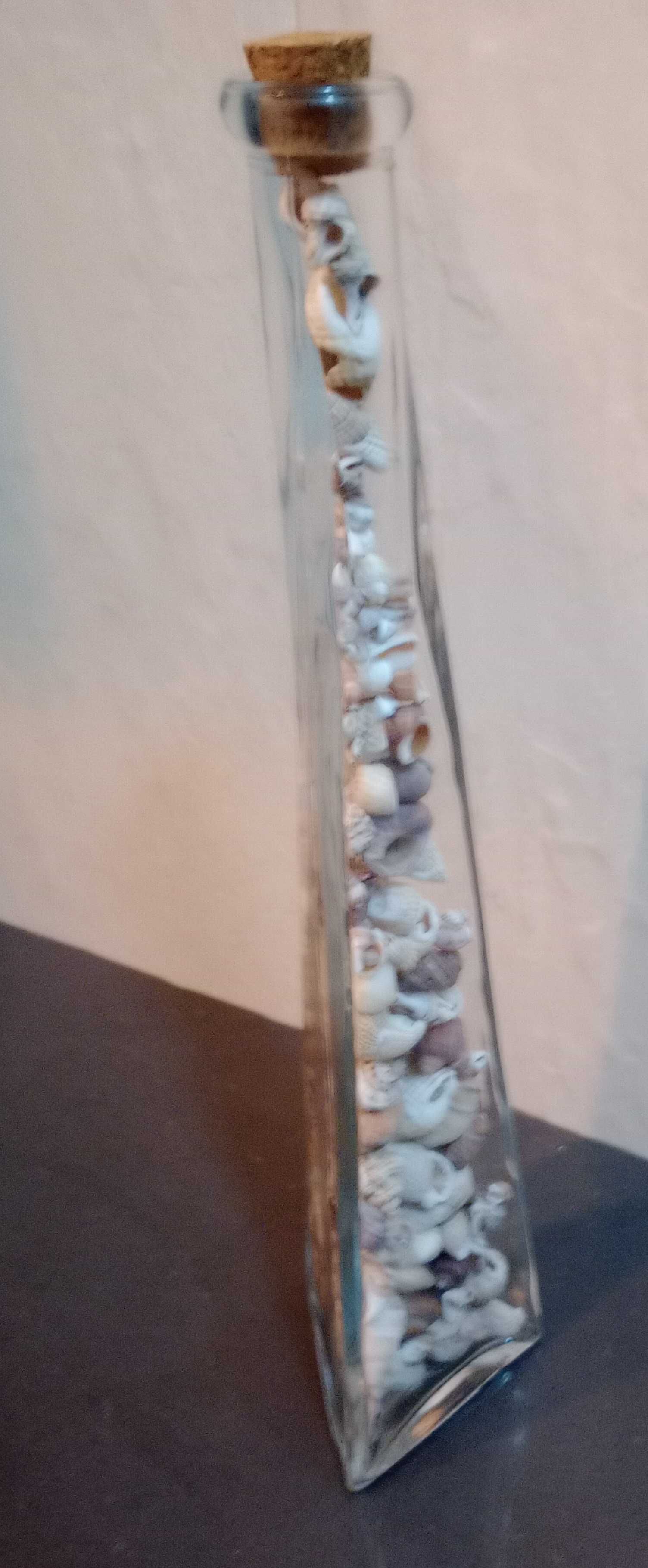Frasco alto Vidro, triangular, c/ vários tipos búzios reais Alt. 32 cm