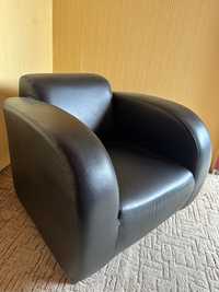 Czarny masywny fotel z eko skóry na nóżkach