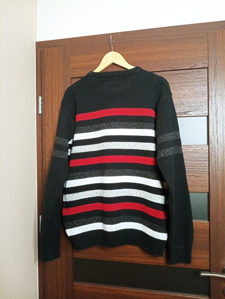 Czarny sweter w białe, czerwone, szare paski